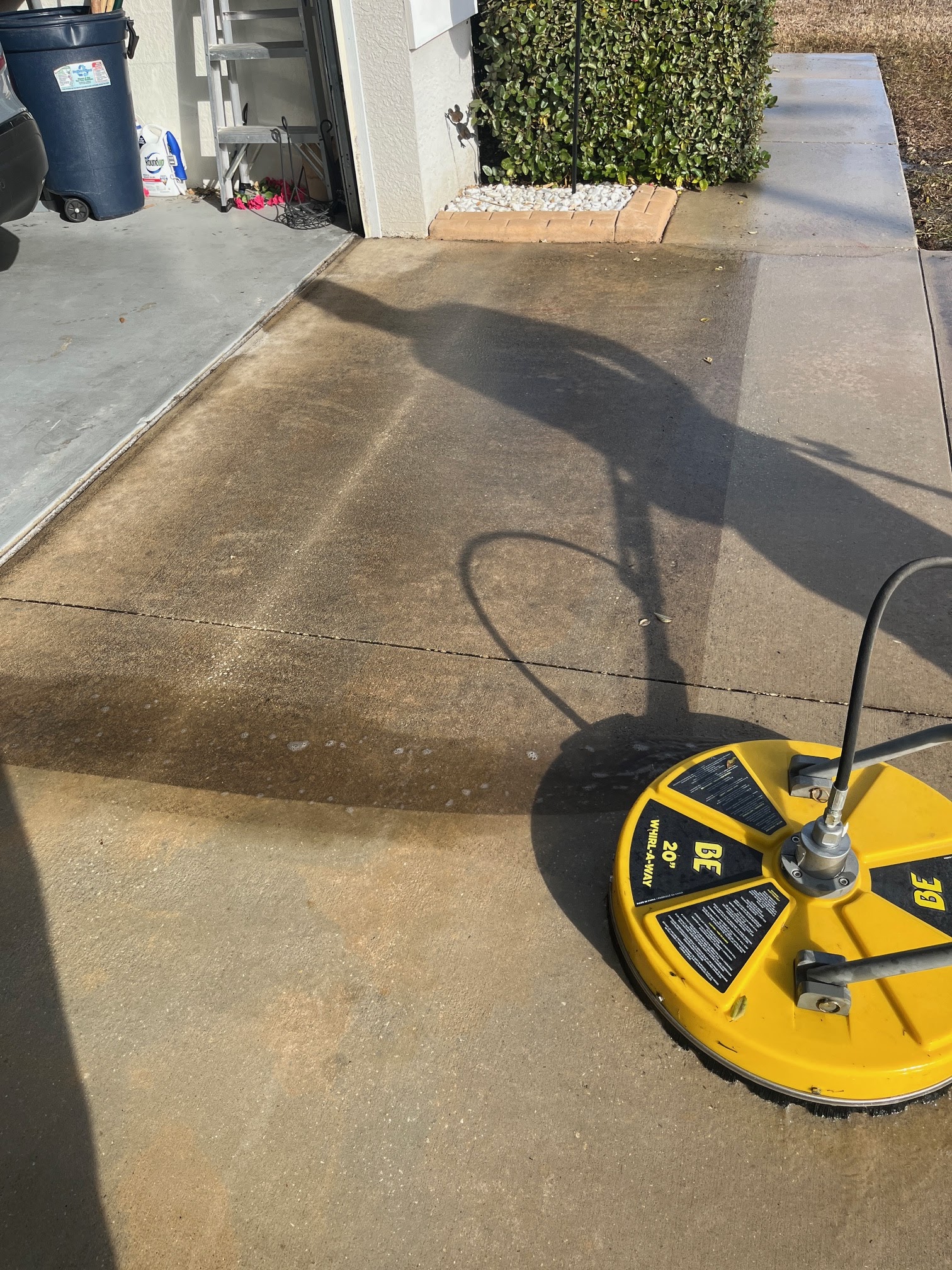 Surface cleaner cutting through driveway grime
